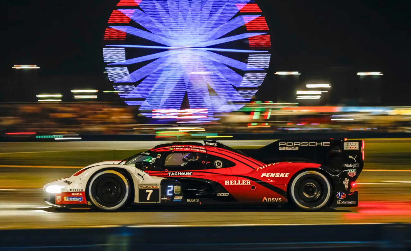 Sports cars racing through the night at Daytona International Speedway