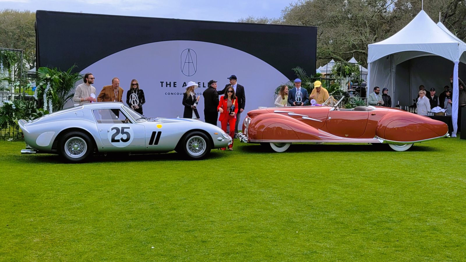 A silver competition Ferrari and a coachbuilt prewar roadster shown side by side as Best in Show winners at the Amelia Island Concours d’Elegance