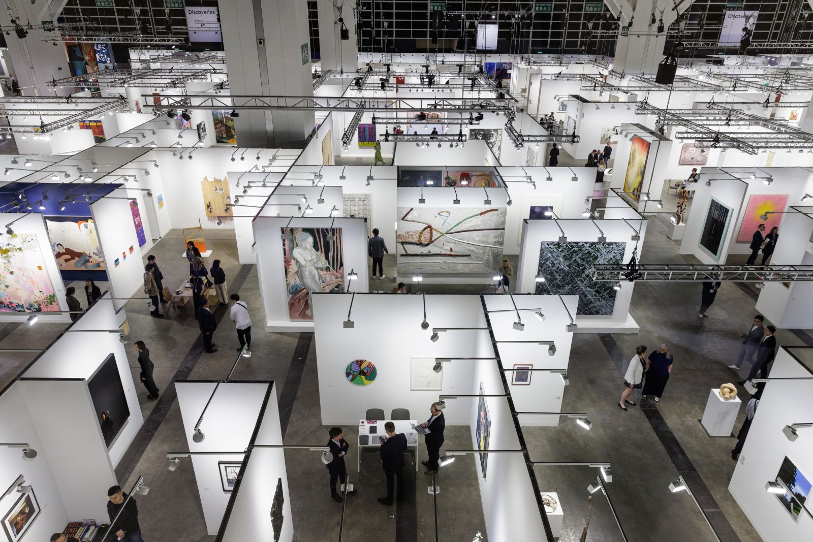 The fair floor and its grid of gallery booths seen from above at Art Basel Hong Kong, an engagement in The Mansa Court season