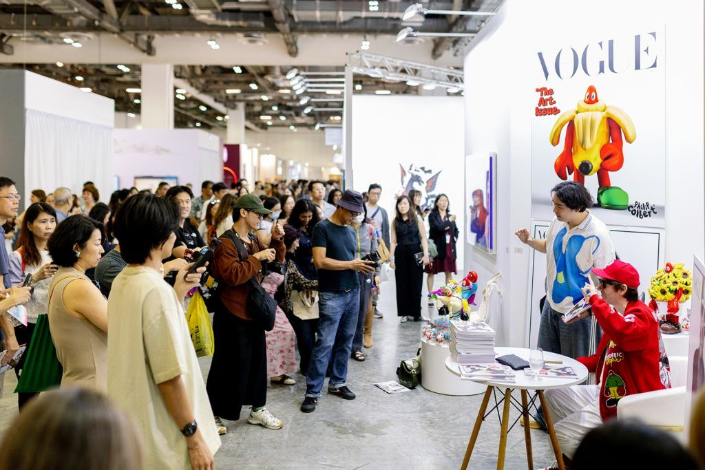 An artist signing at Art SG