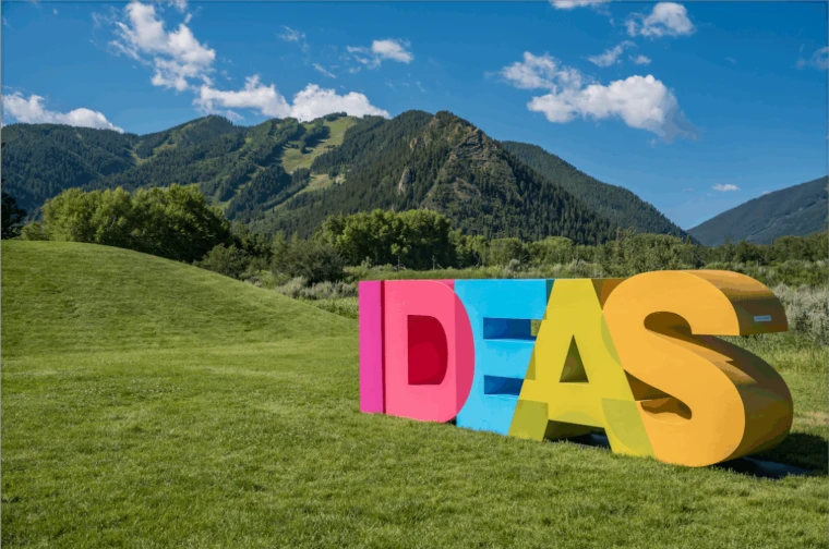 The giant coloured Ideas letters on the grass of Aspen Meadows beneath the forested slopes of the mountains, at the Aspen Ideas Festival, an engagement in the season calendar of The Mansa Court
