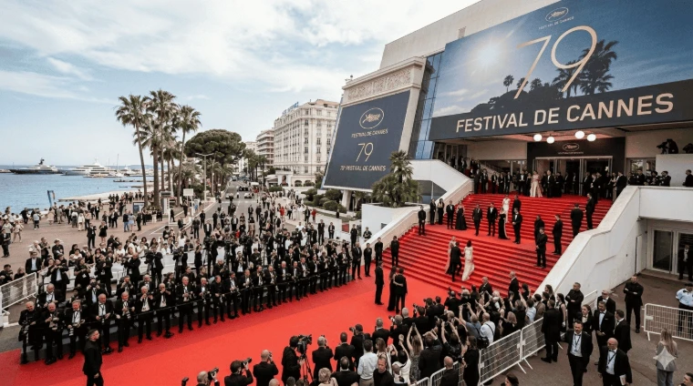 The red carpet and the steps of the Palais des Festivals, photographers massed along the Croisette and yachts in the bay beyond. The Cannes Film Festival at the Palais des Festivals, in the season calendar of The Mansa Court