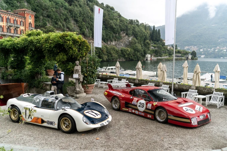 Two endurance racing cars in their period liveries stand on the terrace beside the lake, in 2021. The Concorso d’Eleganza Villa d’Este on Lake Como, in the season calendar of The Mansa Court