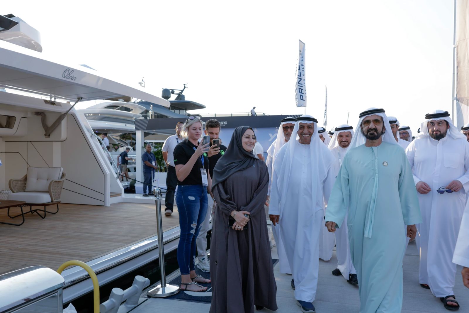 An official party in Emirati dress touring the yacht berths with exhibitors at the Dubai International Boat Show