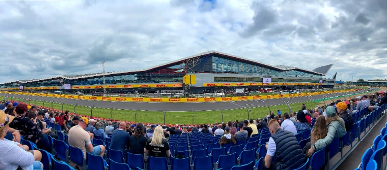 The Silverstone Wing above the start and finish straight, seen from a full grandstand (2021).