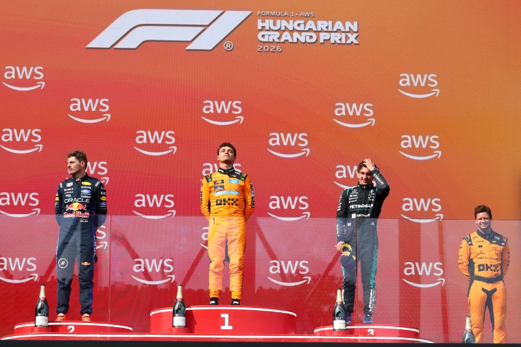 The top three stand on the podium at the 2026 Hungarian Grand Prix. Formula 1 Hungarian Grand Prix, Hungaroring, Mogyoród, in the season calendar of The Mansa Court