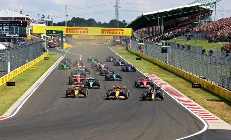 The field streams away from the grid at the start of the Hungarian Grand Prix. Formula 1 Hungarian Grand Prix, Hungaroring, Mogyoród, in the season calendar of The Mansa Court