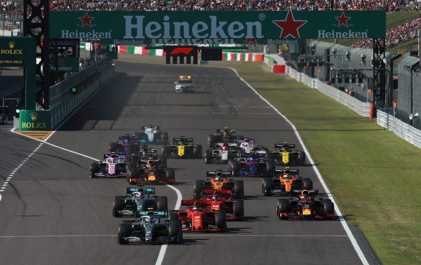 The field launching off the grid down the pit straight at the start of the Formula 1 Japanese Grand Prix, Suzuka, an engagement in The Mansa Court season