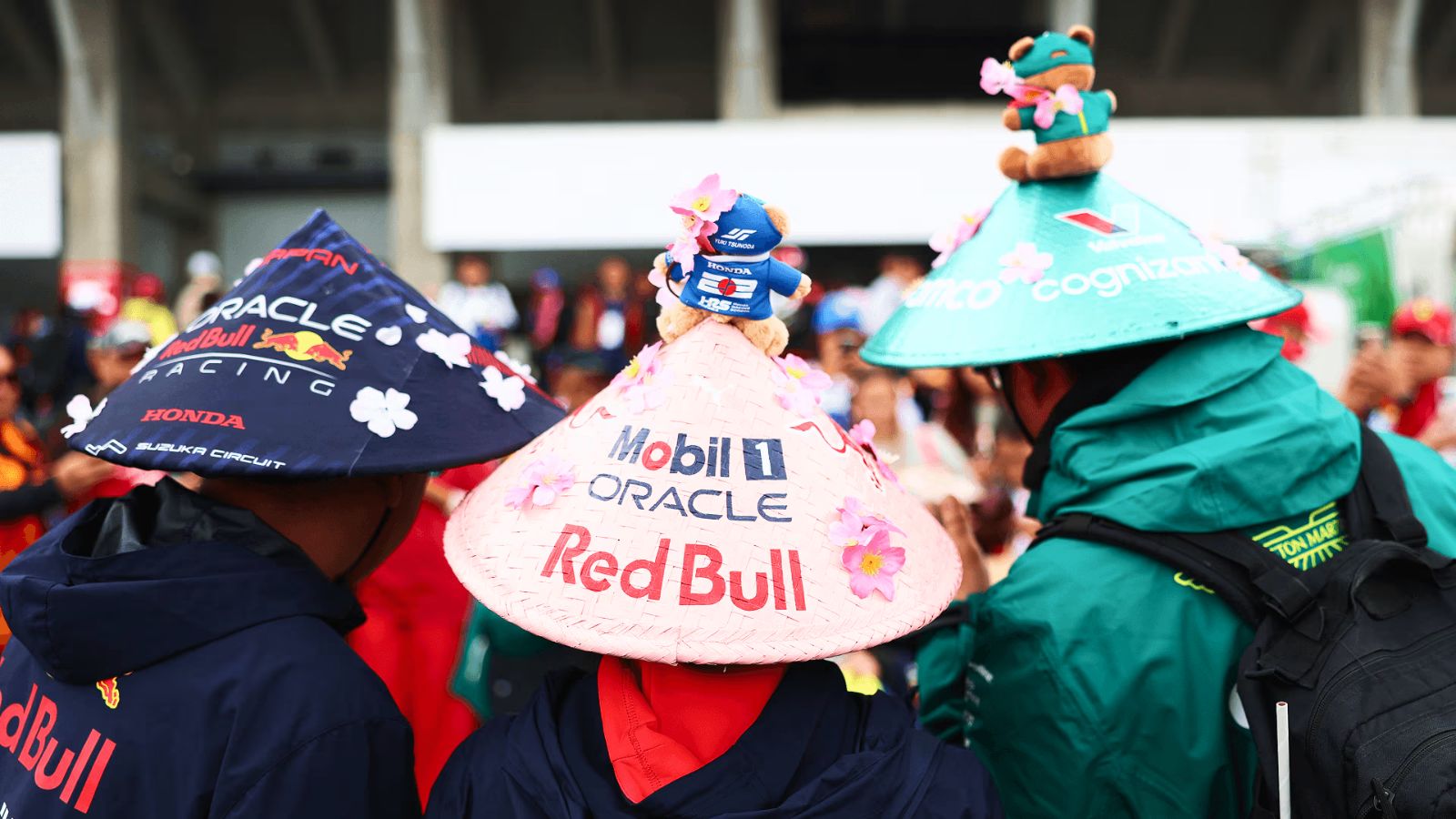 Japanese fans in team-painted straw hats trimmed with cherry blossom in the Suzuka grandstands at the Formula 1 Japanese Grand Prix