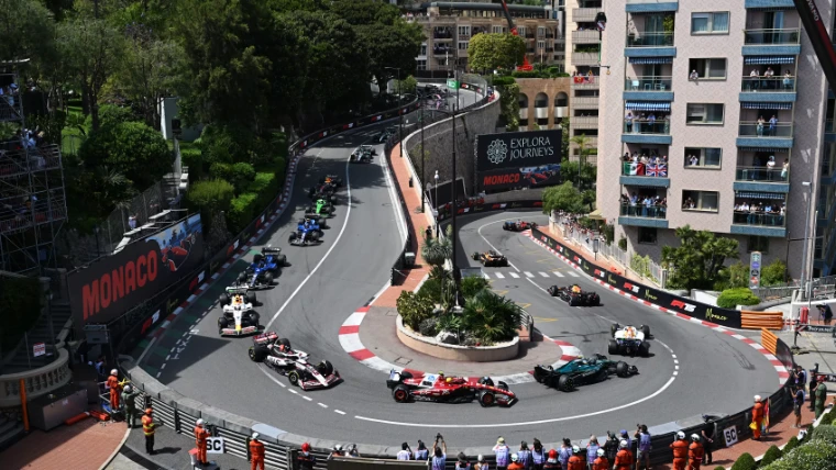 The field winds down to the hairpin beneath balconies full of spectators. The Formula 1 Monaco Grand Prix on the streets of Monte Carlo, in the season calendar of The Mansa Court