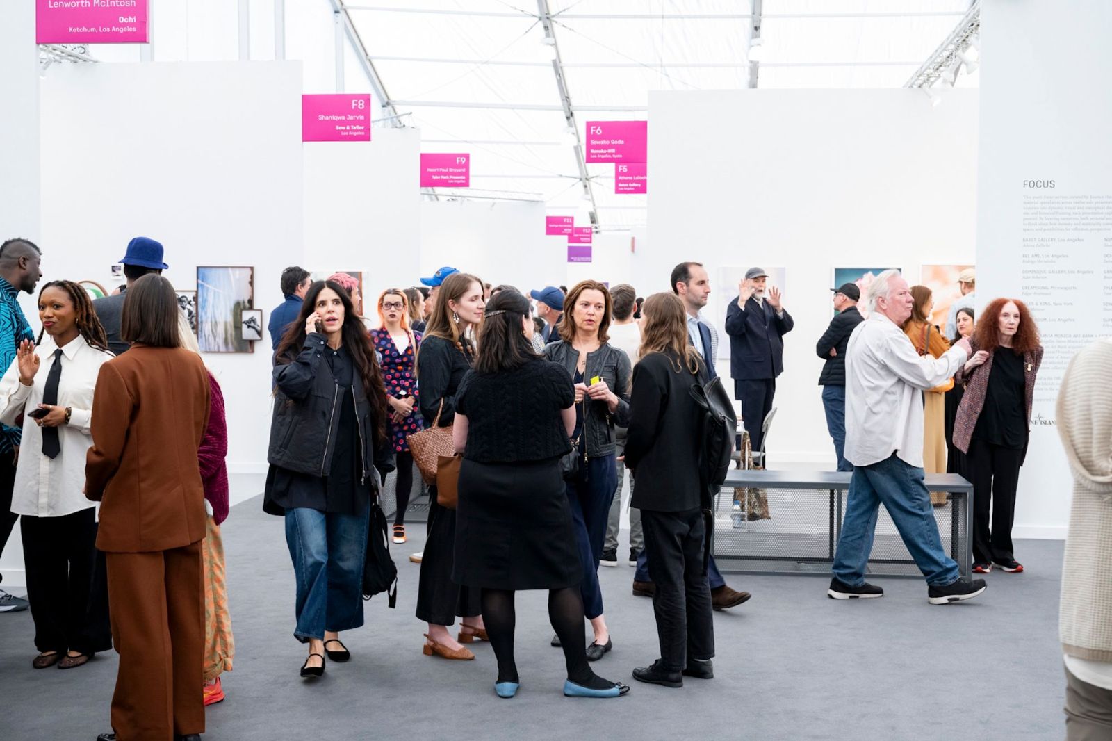 Collectors, dealers and curators talking between the booths of the Focus section at Frieze Los Angeles