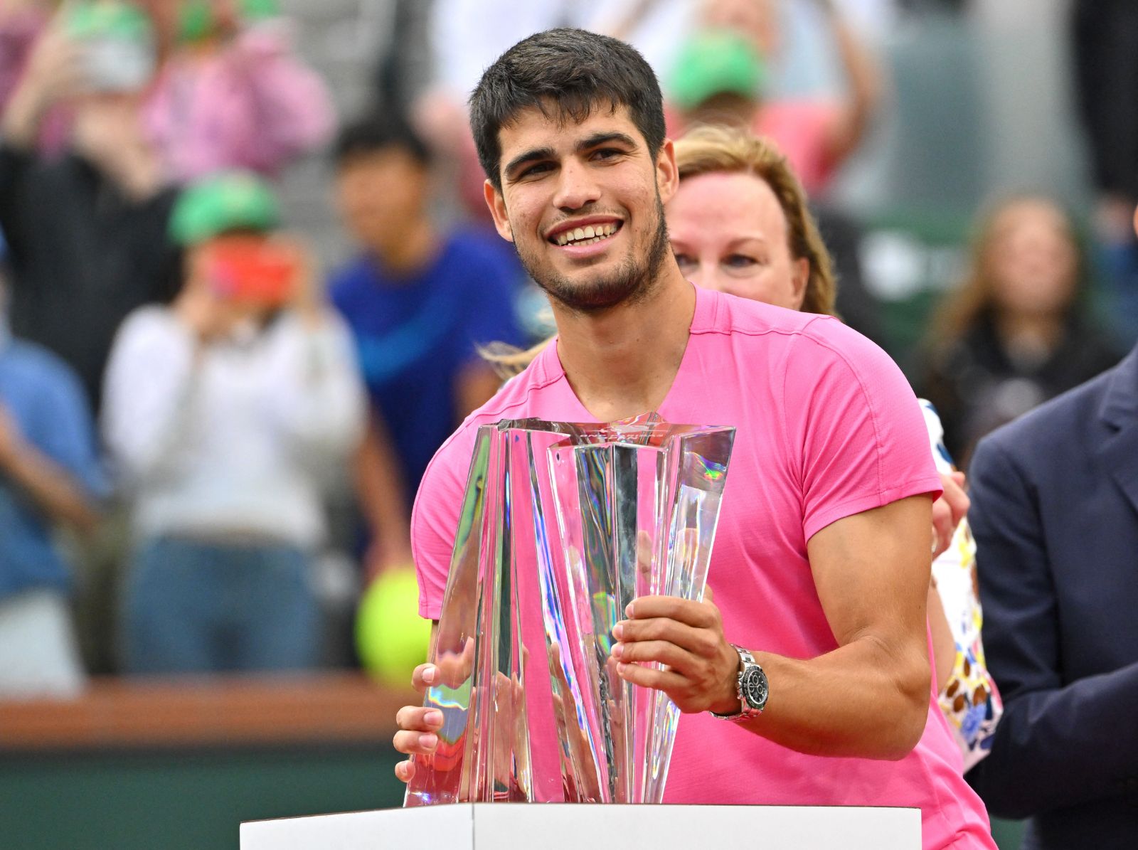 The singles champion holding the crystal trophy after the final at Indian Wells, an engagement in The Mansa Court season calendar