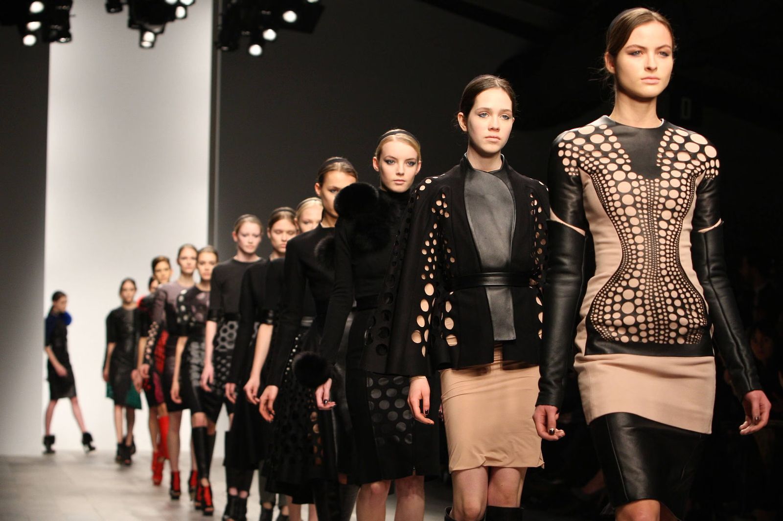 The full cast walking the finale in cut-out leather and black tailoring at London Fashion Week