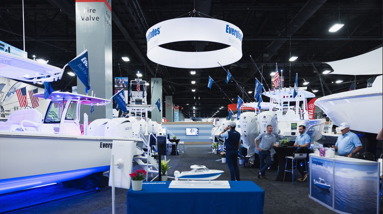 Centre-console boats and outboard displays on the exhibition hall floor at the Miami International Boat Show