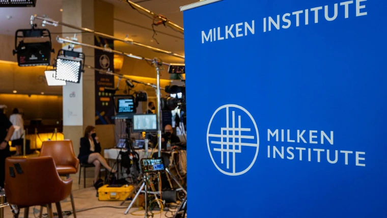 Lights and cameras stand ready at the broadcast set in the lobby, beside a Milken Institute banner, in 2022. The Milken Institute Global Conference at The Beverly Hilton, Beverly Hills, in the season calendar of The Mansa Court