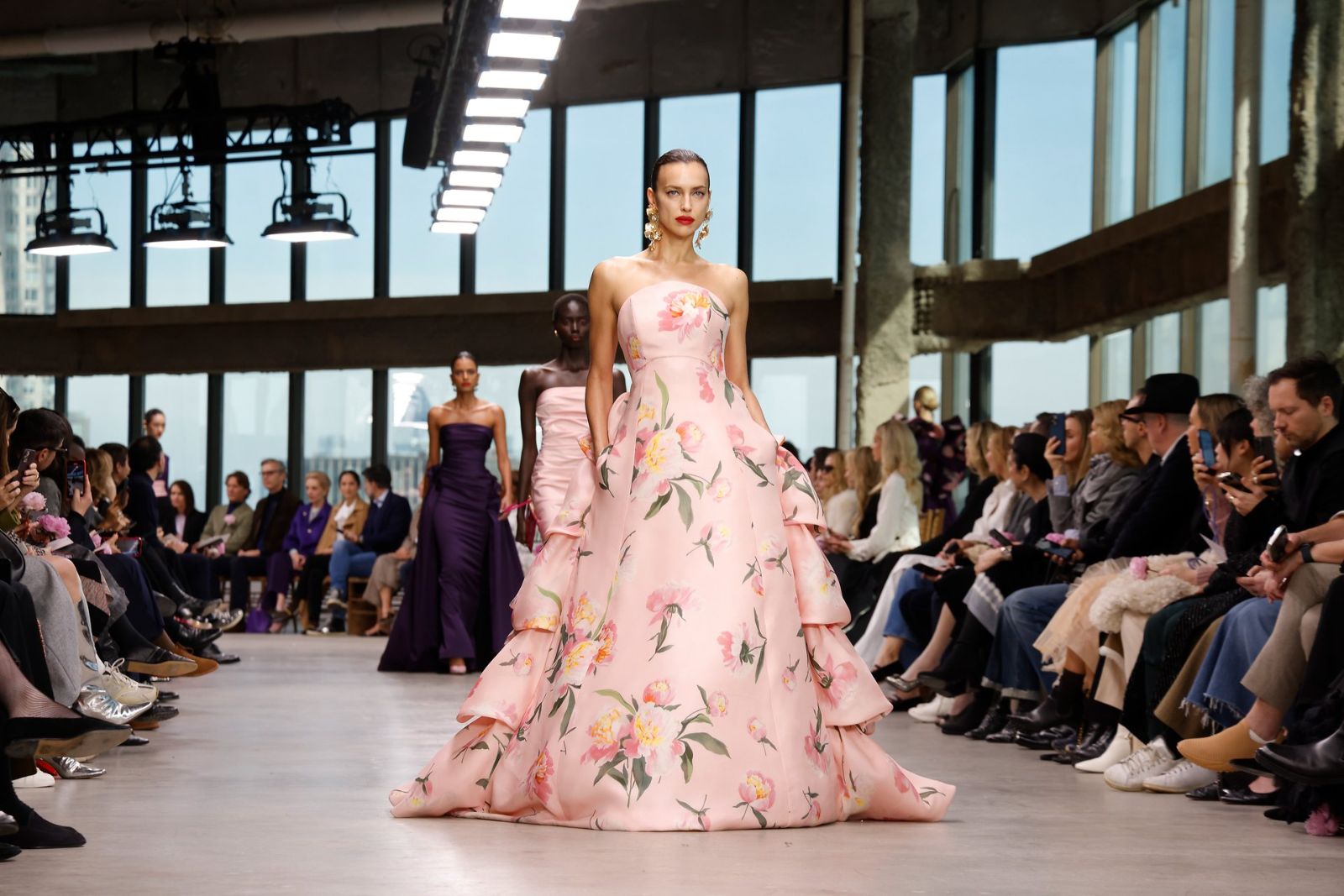 A floral silk evening gown on the runway of a glass-walled New York studio at New York Fashion Week