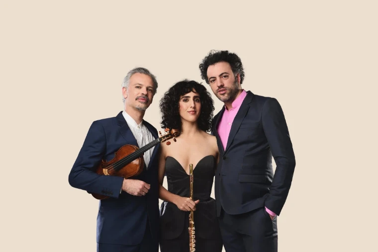 A violinist, flautist and pianist in a studio portrait. A studio portrait, shown for Newport Classical Music Festival in the season calendar of The Mansa Court