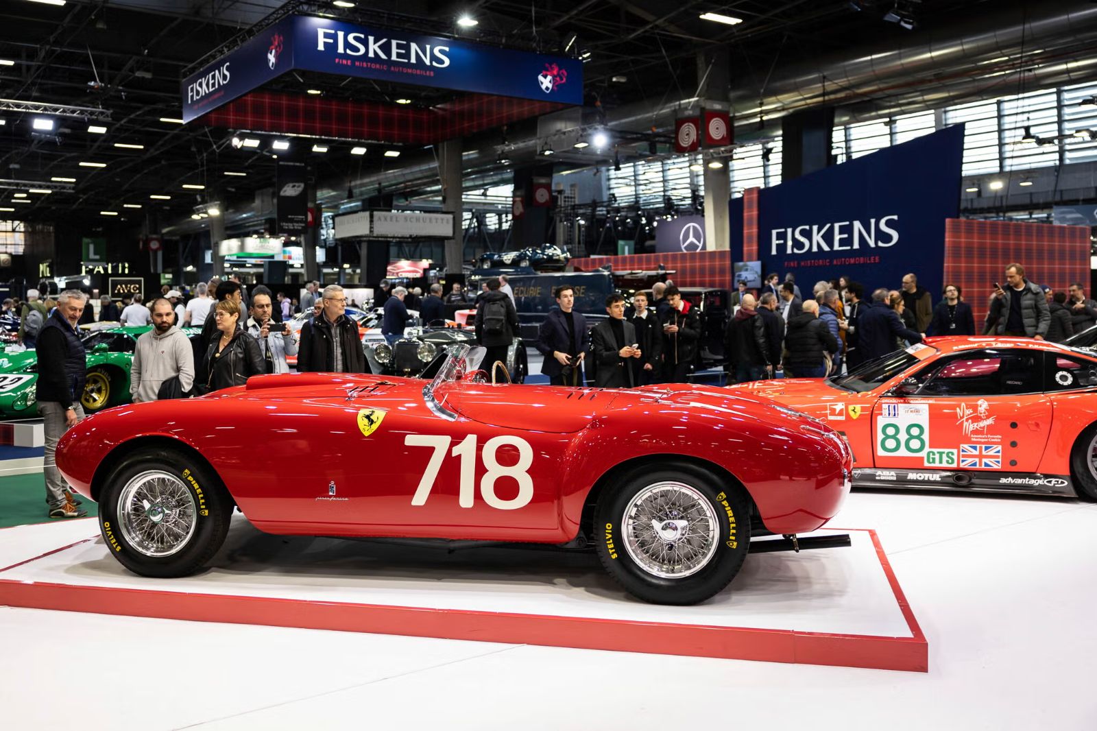 A red Ferrari barchetta numbered 718 on the Fiskens stand at Rétromobile, Paris