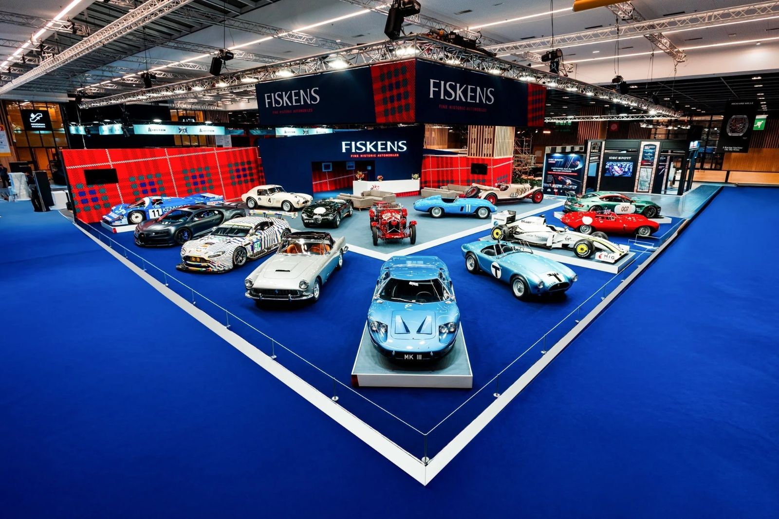 Historic racing and road cars arranged on the Fiskens stand at Rétromobile, Paris