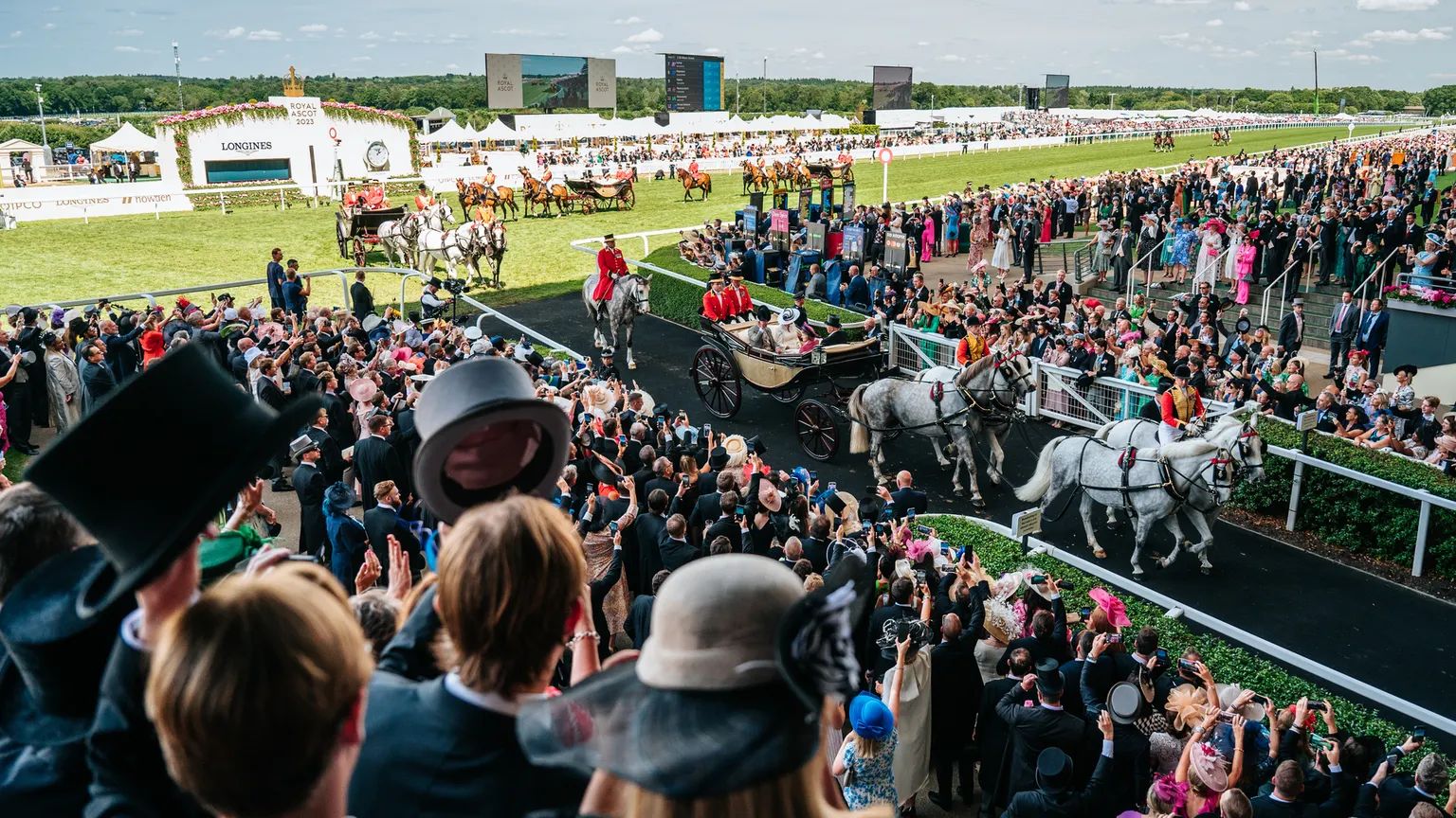 Horse-drawn landaus of the Royal Procession coming down the course at Royal Ascot
