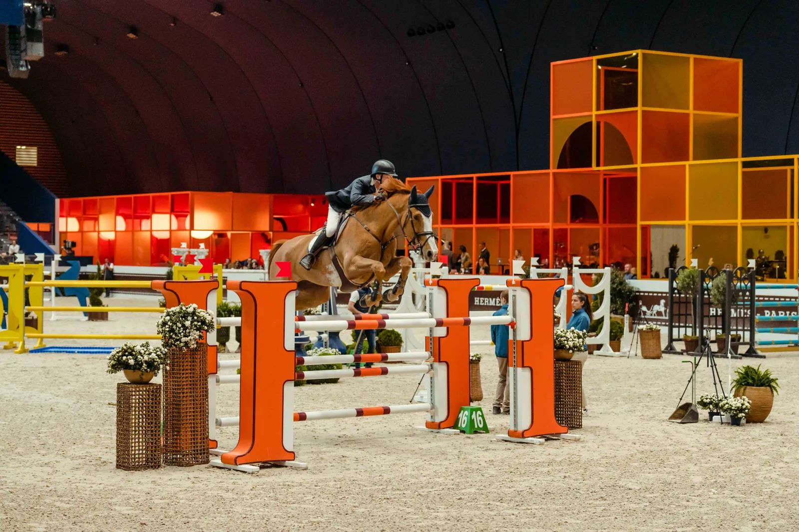 A chestnut clearing the orange H oxer at Saut Hermès, the Paris jumping meeting kept in The Mansa Court calendar