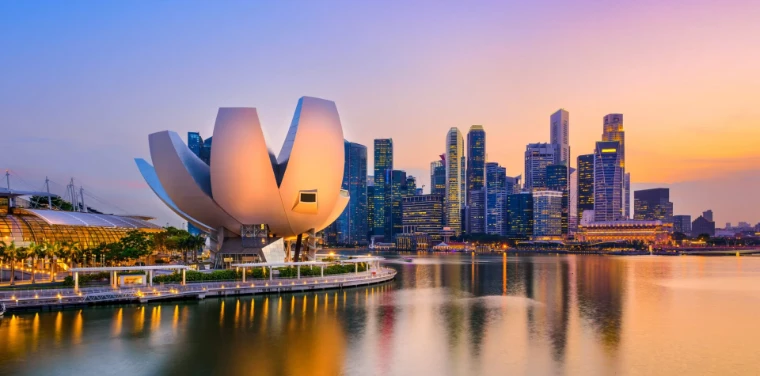 The ArtScience Museum and the towers of Marina Bay reflected in the water at sunset, the city of the Singapore Yachting Festival, a late-April engagement in the season calendar of The Mansa Court