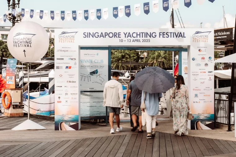 Visitors passing beneath the festival arch onto the marina boardwalk at the Singapore Yachting Festival, a late-April engagement in the season calendar of The Mansa Court