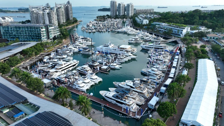 The marina at Sentosa Cove from above, its basin lined with superyachts and show tents at the Singapore Yachting Festival, a late-April engagement in the season calendar of The Mansa Court