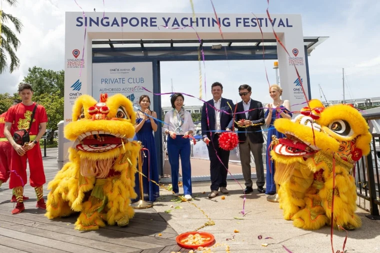 Lion dancers flanking the ribbon-cutting beneath the festival arch at the opening at the Singapore Yachting Festival, a late-April engagement in the season calendar of The Mansa Court