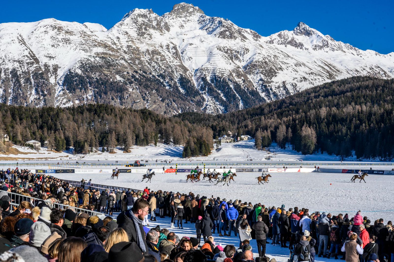 The frozen lake at St. Moritz with the polo field built on the ice and mountains behind