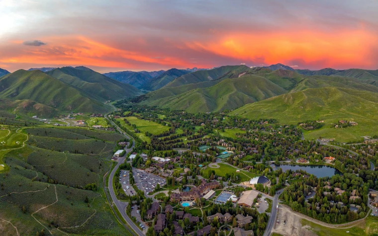 Sun Valley from the air at sunset, the resort and the village among the green hills of the Wood River Valley (2023).