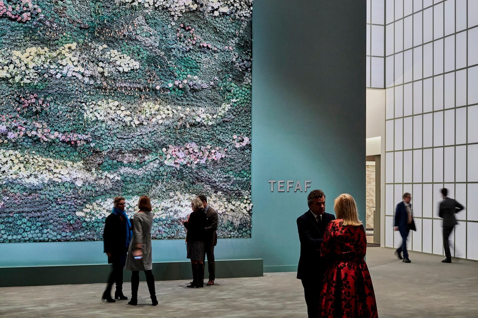 Guests before the flower wall at the TEFAF Maastricht entrance, the March art fair kept in The Mansa Court calendar