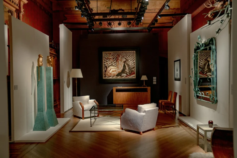 An Art Deco interior of armchairs, gilded monkeys and a verdigris mirror set out in one of the Armory’s period rooms. TEFAF New York at the Park Avenue Armory, in the season calendar of The Mansa Court