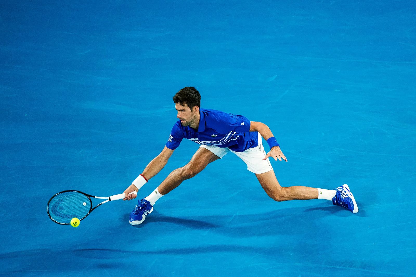 A night match at Melbourne Park, the court glowing against the dark