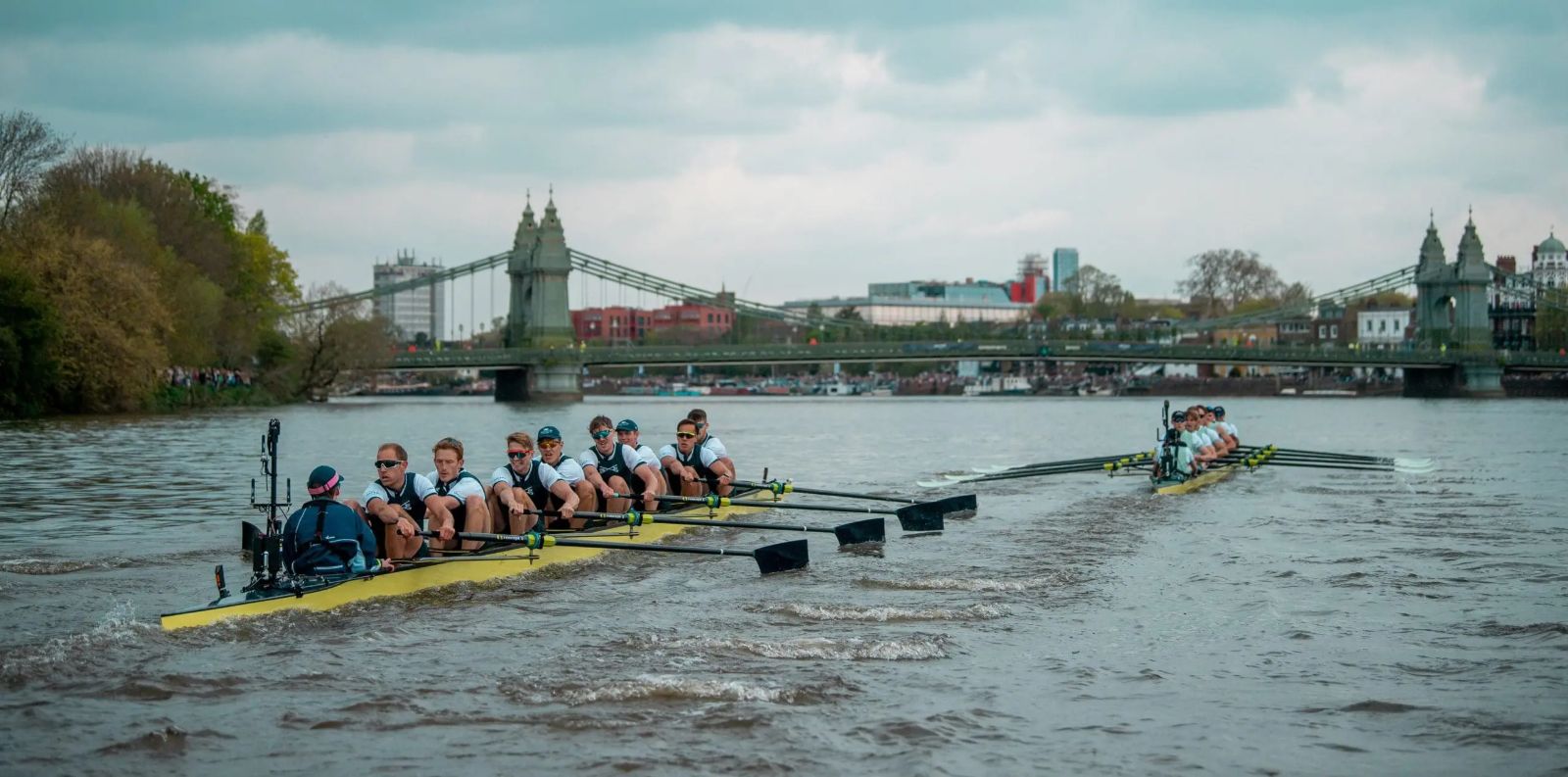 The two eights racing past Hammersmith Bridge on the Championship Course at The Boat Race, the spring fixture on the Tideway kept in The Mansa Court calendar