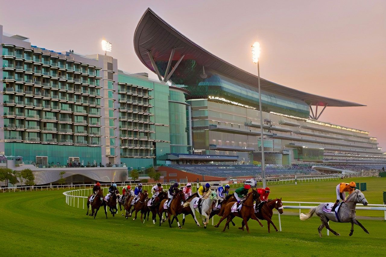 The field on the turf past the Meydan grandstand at dusk on Dubai World Cup night, the March meeting The Mansa Court keeps in its calendar