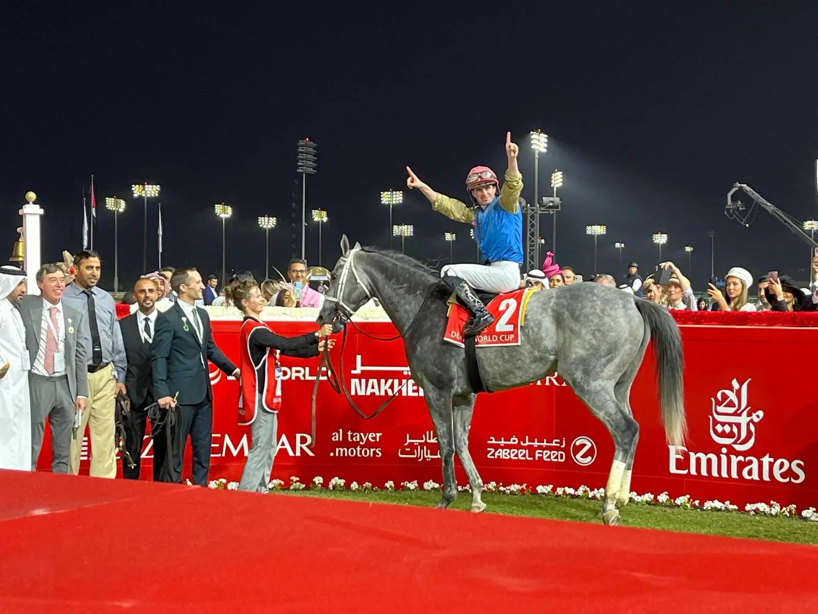 A winning jockey saluting on a grey in the winner’s enclosure at the Dubai World Cup, Meydan, kept in The Mansa Court calendar