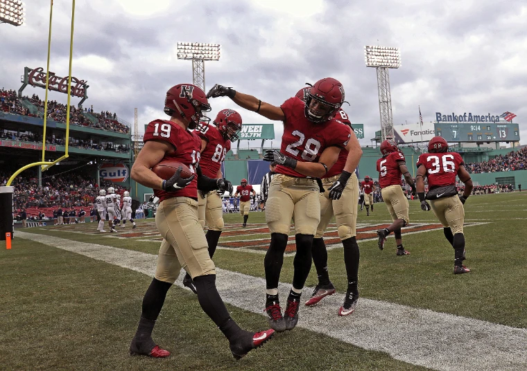 Harvard players celebrate a touchdown at Fenway Park. The Game, Harvard v Yale, Fenway Park, Boston (17 November 2018), in the season calendar of The Mansa Court
