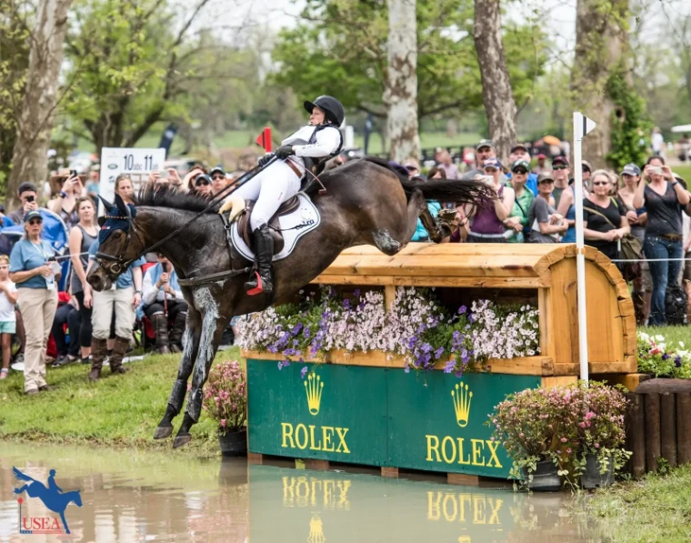 A horse and rider dropping over a flower-topped fence into the water on the cross-country course before the crowd at the Kentucky Three-Day Event, a late-April engagement in the season calendar of The Mansa Court