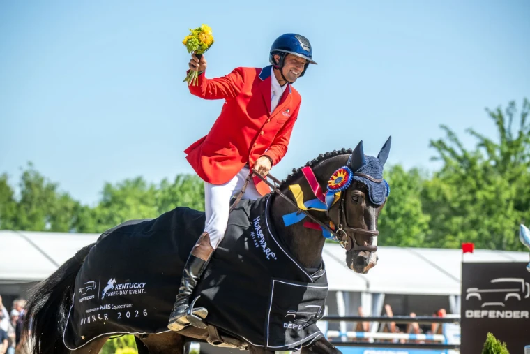 The winning rider in a red coat raising a bouquet from the saddle, his horse in the winner’s rug and rosette, at the Kentucky Three-Day Event, a late-April engagement in the season calendar of The Mansa Court