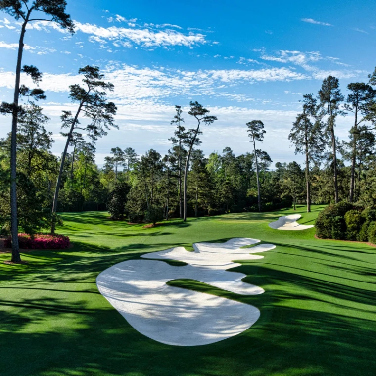 White fairway bunkers, azaleas and Georgia pines on the course at Augusta National Golf Club, the setting of The Masters in the season calendar of The Mansa Court
