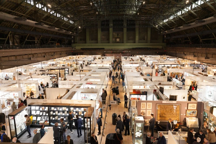 Rows of dealers’ stands under the iron trusses of the Armory’s Drill Hall, seen from above. The New York International Antiquarian Book Fair, Wade Thompson Drill Hall, Park Avenue Armory, New York, in the season calendar of The Mansa Court