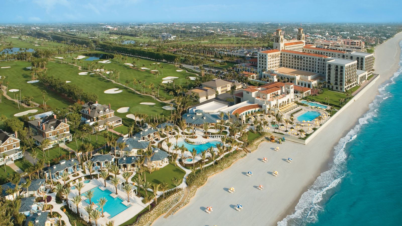 The island of Palm Beach from the air, golf courses and pools running down to the beach