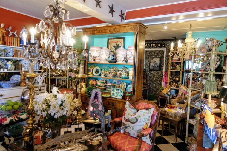 An antiques shop crowded with crystal chandeliers, majolica, blue-and-white porcelain and upholstered chairs, the trade behind The Palm Beach Show, an engagement in the season calendar of The Mansa Court