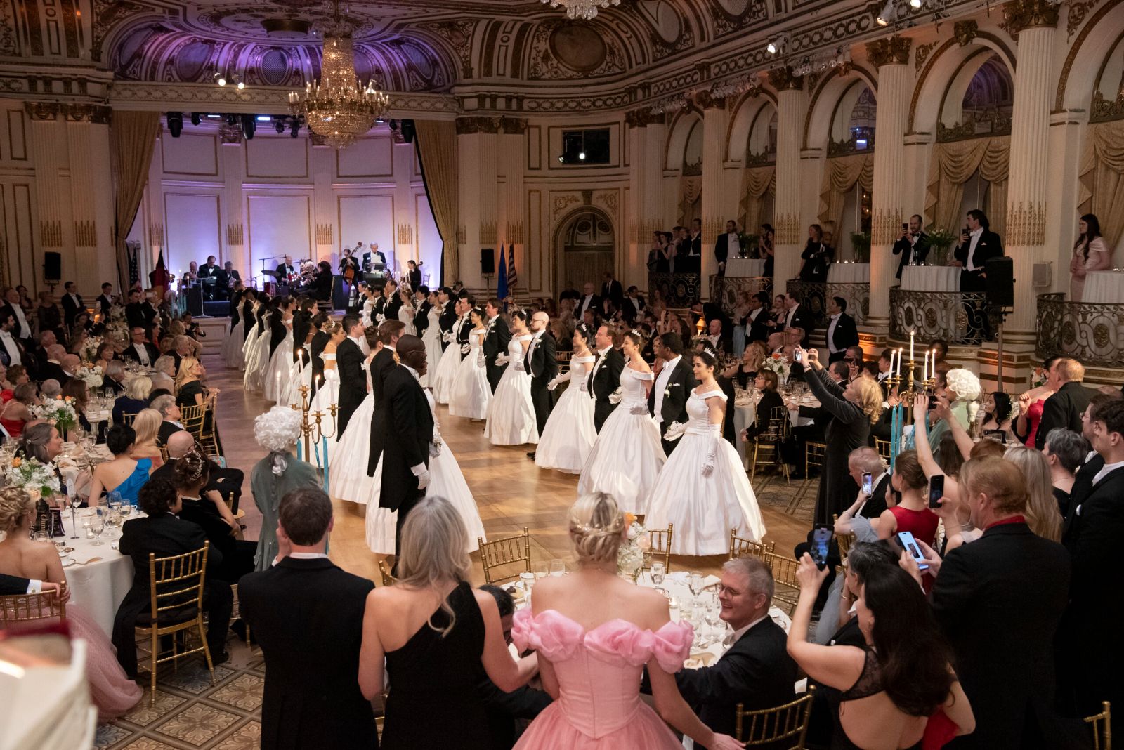 The presentation of debutantes in white gowns and escorts in white tie at The Quadrille Ball, The Plaza, New York
