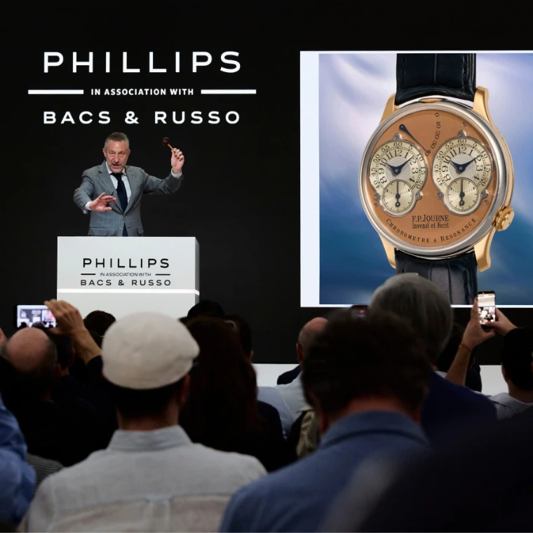 The auctioneer raises the gavel at a Phillips watch sale as a rare independent chronometer fills the screen. The spring auctions in New York, in the season calendar of The Mansa Court