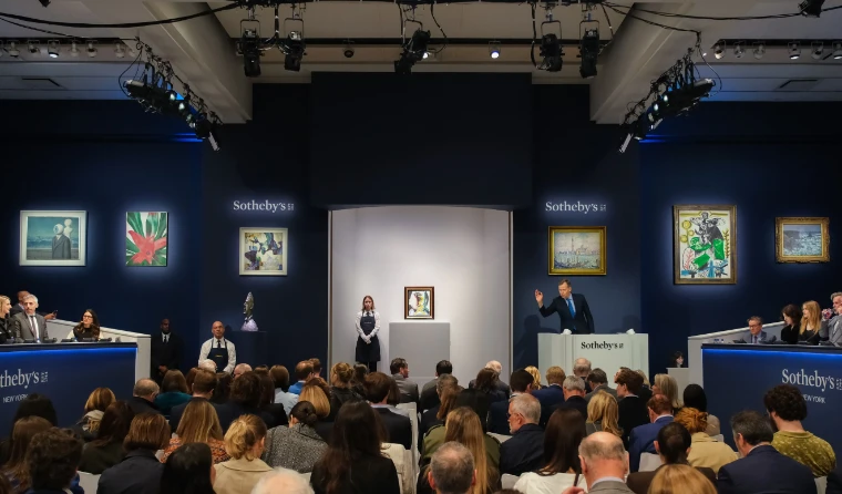 The auctioneer takes a bid in the Sotheby’s New York saleroom, telephone banks on either side and modern pictures on the walls. The spring auctions in New York, in the season calendar of The Mansa Court
