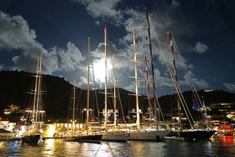 Superyachts lit at night along the quay in Gustavia during the Bucket. The St. Barths Bucket, Gustavia harbour, St. Barthélemy, in the season calendar of The Mansa Court