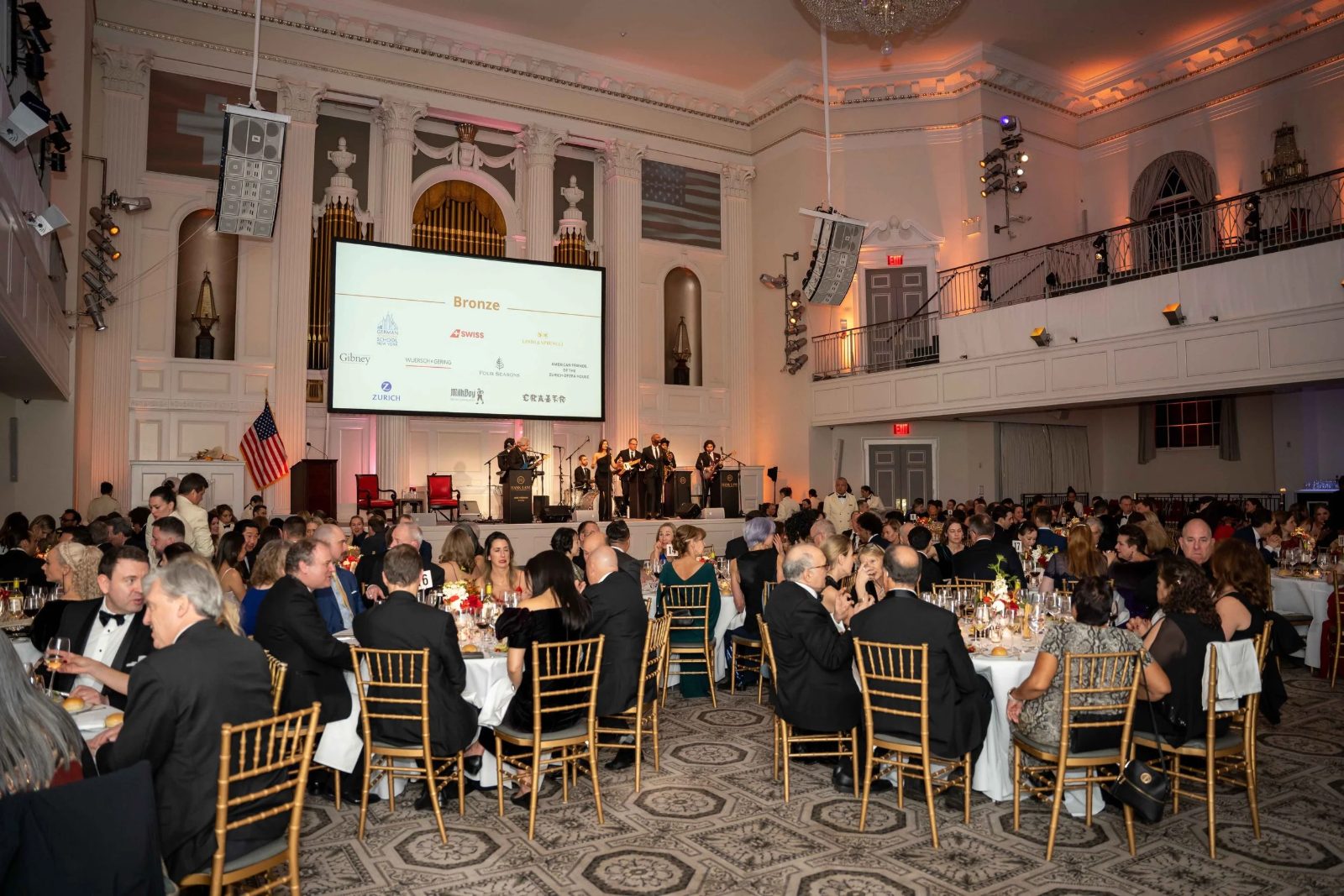 Guests at candlelit round tables during dinner in the ballroom at The Swiss Ball, the black-tie evening in New York kept in The Mansa Court calendar