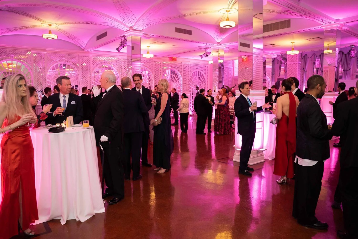 Guests in black tie and evening gowns at the drinks reception before The Swiss Ball in New York, an engagement in The Mansa Court season